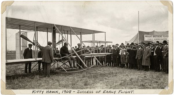 Early aviation pioneer in a biplane, representing the Blériot phase of systematizing a new technology