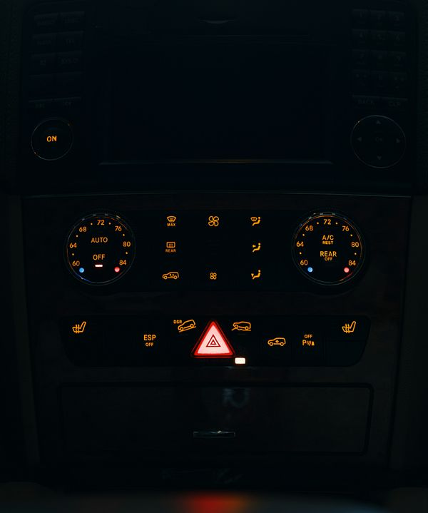 Car dashboard controls glowing in the dark, representing AI-driven vehicle intelligence